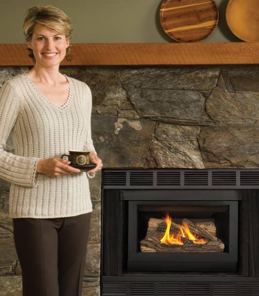 Woman standing by gas fireplace