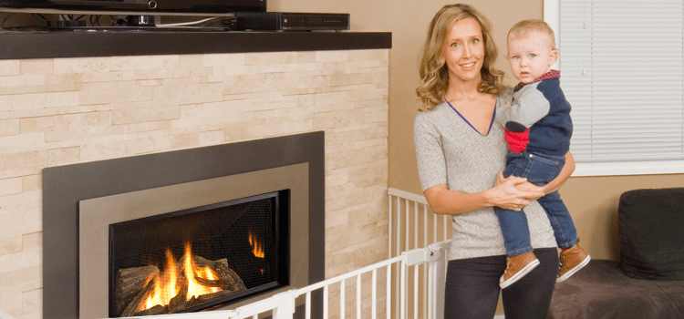 Woman standing by Fireplace holding Son in her arms