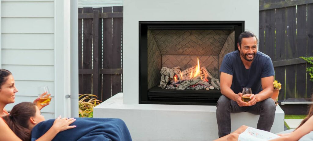 Family Sitting By Outdoor Gas Fireplace